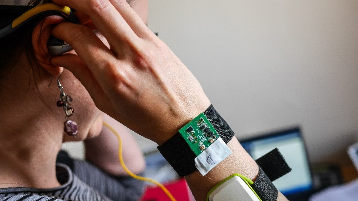 Person adjusting wearable technology on their head
